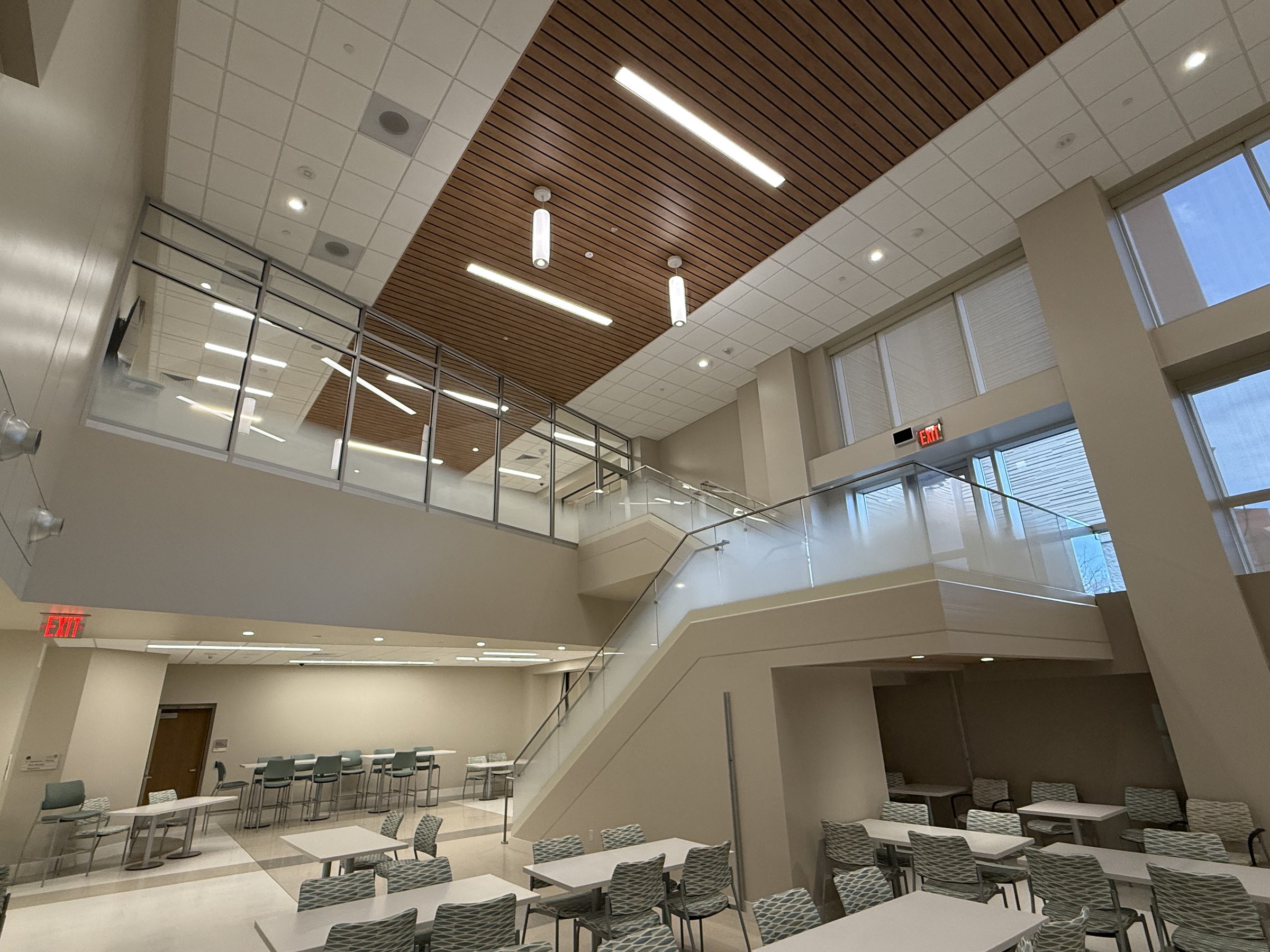 Glass guard along the open landing and stair of a two-storey commons, Fort Leonard Wood