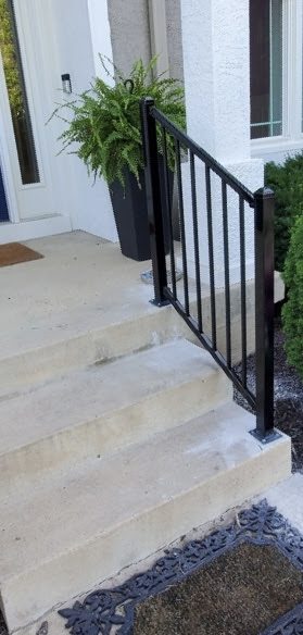 Ameristar two-rail steel handrail with standard caps beside front steps