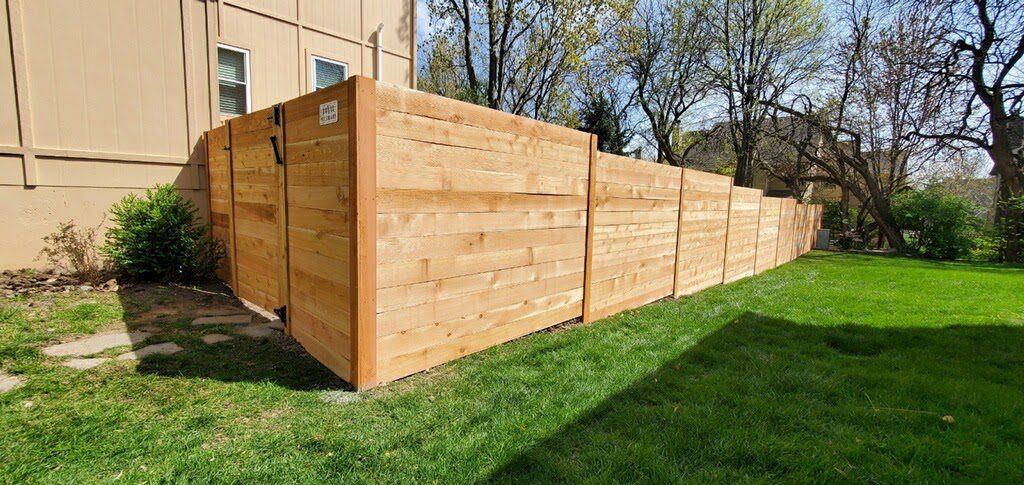 Six-foot horizontal cedar privacy fence beside a house