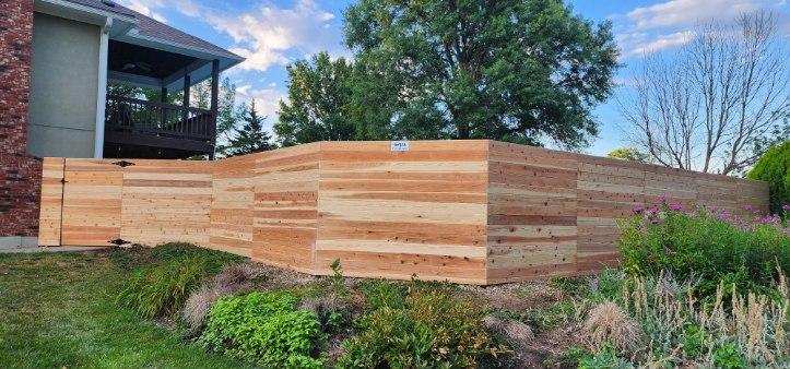 Six-foot horizontal premium cedar fence along a landscaped yard