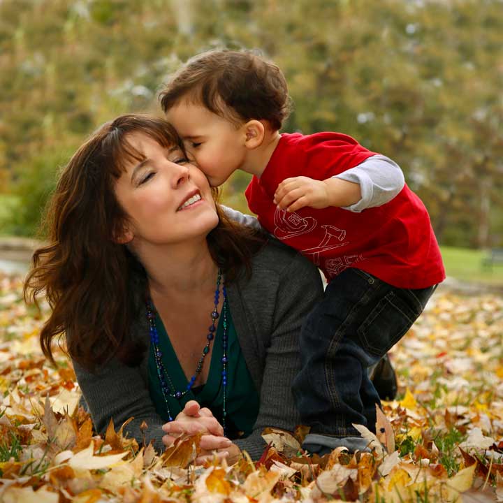 A mother and her son, in the leaves
